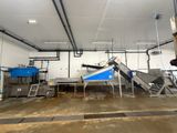 an image of a factory with a conveyor belt in the middle of the room