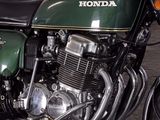 a green and black motorcycle parked in a garage