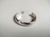 a close up of a silver ring on a white surface