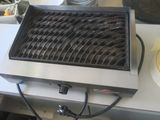 a grill that is sitting on a counter with a plate of food