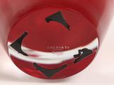 a close up of a red vase with black designs on it