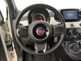 the interior of a small car with a steering wheel and dashboard controls