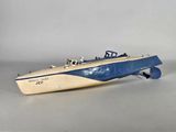 an old model of a small boat with a blue and white stripe