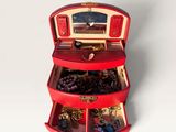 a small red box with a bunch of jewelry inside of it