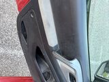 a red car with a broken door and a broken window