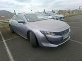 a silver car parked in a parking lot with other cars in the background