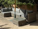 a couch and a table under an umbrella on the patio