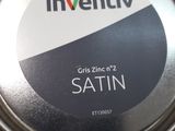 a silver tin with a black and white label on it