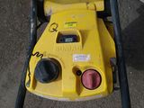 a yellow machine that is sitting on the ground