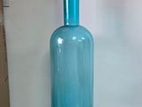 une bouteille en verre bleue surmontée d'une boule rouge