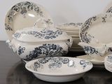 a lot of plates and bowls on the table