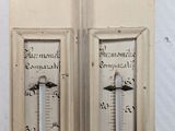 two thermometers on the door of a building