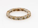 a close up of a diamond ring on a white surface