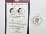 the commemorative coin is displayed next to the certificate of authenticity