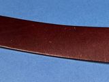a knife that is laying on top of a blue surface