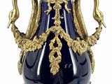 a large blue vase with a gold decoration on it