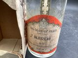 a bottle of wine sitting on a table next to a cardboard box