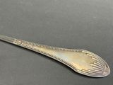 an antique silverware spoon with a decorative design on it