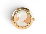 an image of a woman ' s profile in a gold plated ring