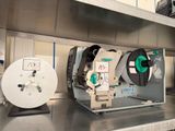 many reels of tape on a shelf in a room