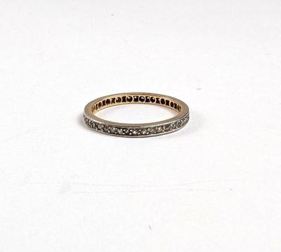 gros plan d'une bague en or et diamants sur une surface blanche