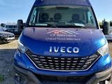 the blue van is parked in a lot with other vehicles in the background