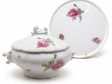 a white bowl with a lid and a plate with a pink rose on it