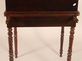 a small wooden table with a drawer on top of it
