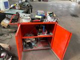 a red cabinet with tools on it in a garage