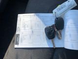 a car key and a book sitting on the seat of a car