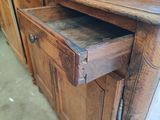 a wooden cabinet with a drawer on top of it