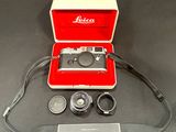 a red case with a camera and a lens in it