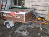a trailer with a boat on it in a garage