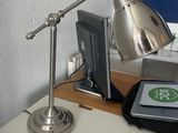 a desk with a laptop and a lamp on it