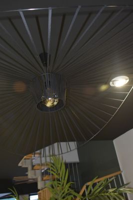 a large black umbrella hanging from the ceiling in a room