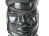 a black statue of a man with a hat on