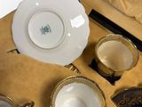 three cups and saucers in a box on a table