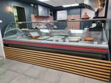 an image of a deli counter with a variety of food in it