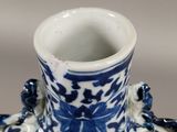 a blue and white vase sitting on a table
