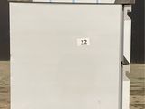 an image of a white refrigerator in a parking lot