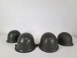 three helmets are lined up on a white surface