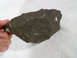 a person holding a piece of rock in their hand