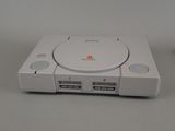 a white game console sitting on top of a table