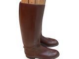 pair of brown leather boots with wood in them on a white background