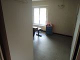 a room with a desk and a window in it