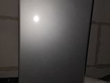 a refrigerator that is sitting in the corner of a room