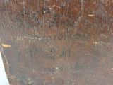 a piece of wood that has been scratched off and is sitting on a table