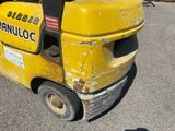 a yellow forklift truck that is parked in a parking lot