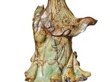 statue of a woman holding a bird on a white background