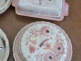 several plates and bowls are sitting on a wooden table